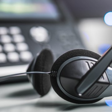 axvoice voip service benefits voip phone in the background headset in the front 